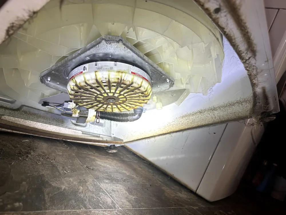 Corroded washer drive assembly underneath the machine before repair