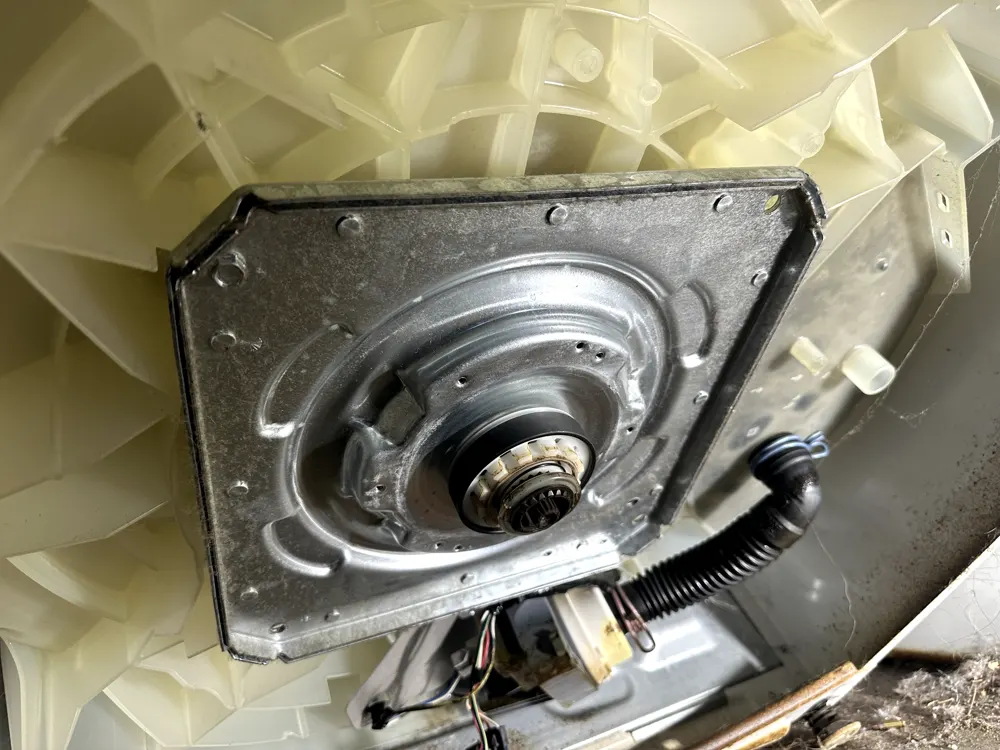 New tub bearing installed on cleaned mounting plate